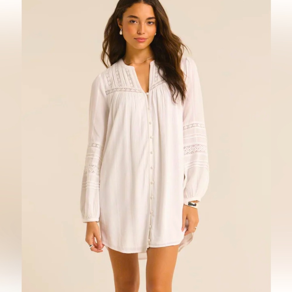 Peasant style button front mini dress. Delicate details like lace insets.